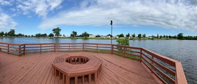 Wood deck and railing overlooking a pond